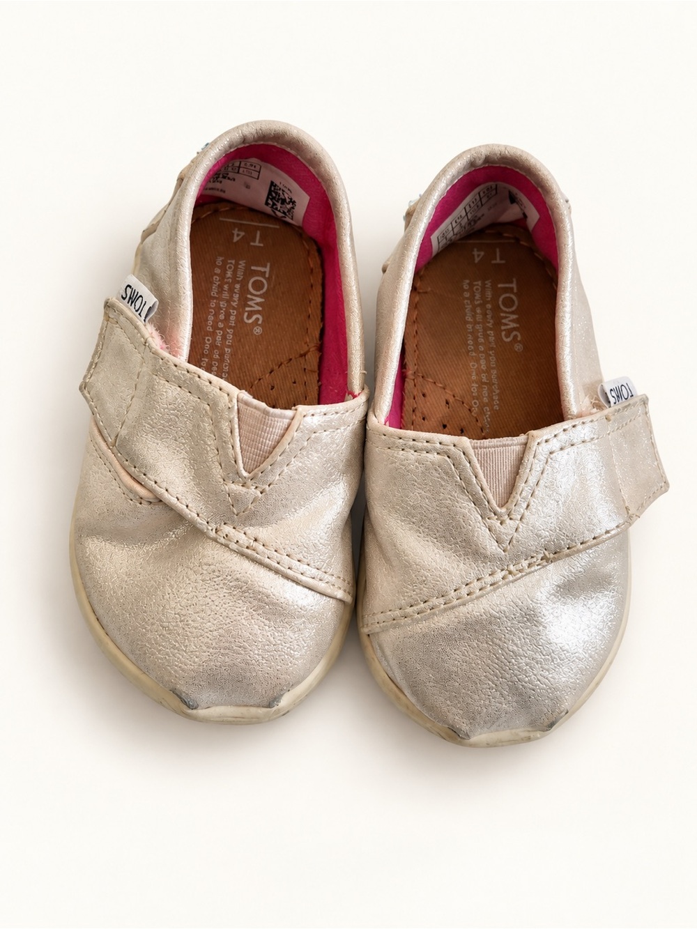 Toms Kids Metallic Gold Slip-On Shoes with Pink Lining